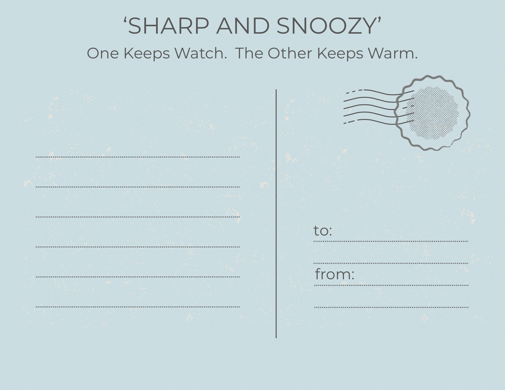 A light blue postcard-style print with the text 'SHARP AND SNOOZY' and the subtitle 'One Keeps Watch. The Other Keeps Warm.